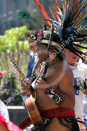 Aztec indian man wearing a head dress of pheasant feathers dances the Los Concheros during a celebration for the Day of the Dead in Mexico City, Mexico.