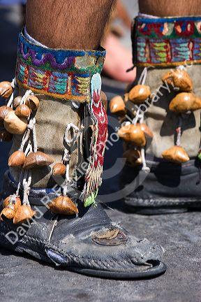 Aztec indian wearing boots with nutshells during a celebration for the Day of the Dead in Mexico City, Mexico.