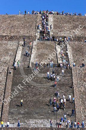 Tourists climbing the steps of the Pyramid of the Sun at Teotihuacan in the State of Mexico, Mexico.