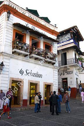 People and storefronts in the plaza at Taxco in the State of Guerrero, Mexico.