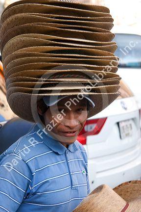 Mexican street vendor selling hats in the plaza at Taxco in the State of Guerrero, Mexico.