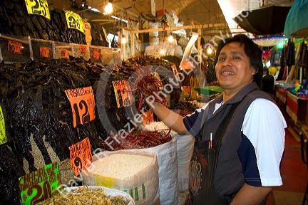 Vendor selling dried peppers at the Merced Market in Mexico City, Mexico.