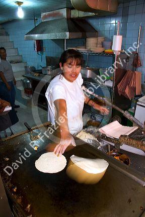 Mexican woman making corn tortillas at the Merced Market in Mexico City, Mexico.