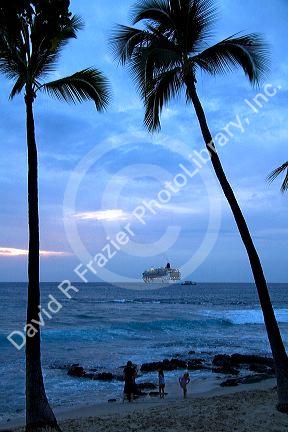 Cruise ship at sunset in the Pacific Ocean off the coast of the Big Island of Hawaii.