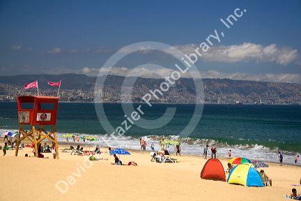 Beach scene in Renaca on the Pacific Ocean in Chile with Vina del Mar and Valparaiso in the background.