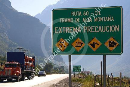 Spanish language road sign warning of hazardous road conditions at the foot of the Andes Mountain Range in Chile.