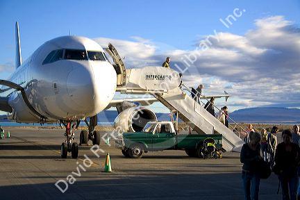 Passengers disembark an airplane at the El Calafate International Airport in Patagonia, Argentina.