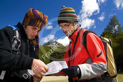 Hikers from Israel look at a map in the Tierra del Fuego National Park, Argentina. MR