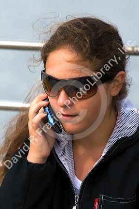 Girl talks on a cell phone at Ushuaia on the island of Tierra del Fuego, Argentina.