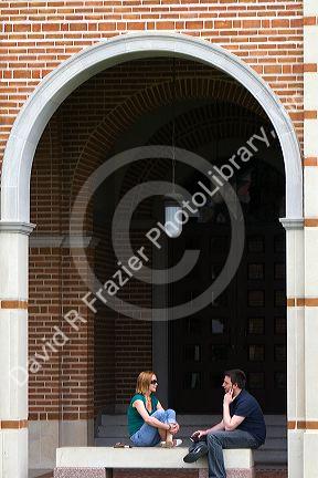 Students sit under an archway at Lovett Hall on the campus of William Marsh Rive University in Houston, Texas. MR