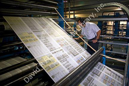Newspaper being printed on a rotary printing press for the Houston Chronicle in Houston, Texas.