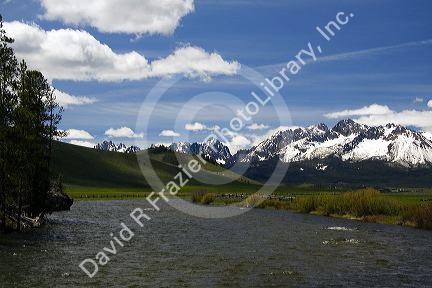 The Salmon River flowing through the Sawtooth Valley below the Sawtooth Mountain Range near Stanley, Idaho.