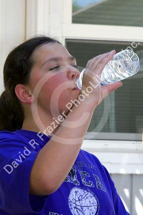 11 year old girl drinking water on a hot summer day in Boise, Idaho. MR