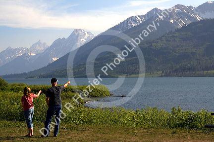 Tourists view the Teton Range at Jackson Lake in Grand Teton National Park, Wyoming.