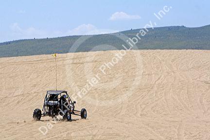 Dune buggy driving on sand dunes at St. Anthony, Idaho.