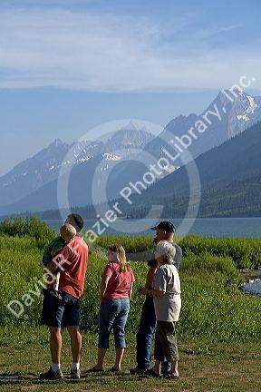 Family viewing the Teton Range at Jackson Lake in Grand Teton National Park, Wyoming.