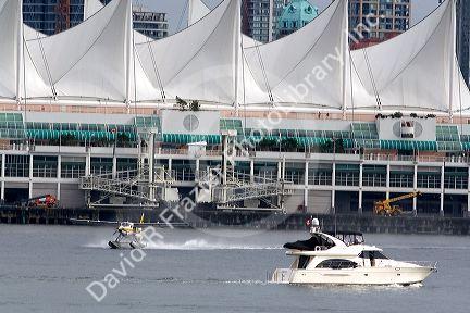 Seaplane and boat in front of Canada Place in Vancouver, British Columbia, Canada.