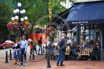 People dine at a sidewalk cafe in the Gastown area of Vancouver, British Columbia, Canada.