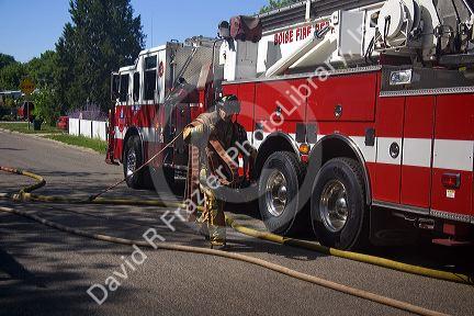 Firefighter carrying hose in Boise, Idaho.