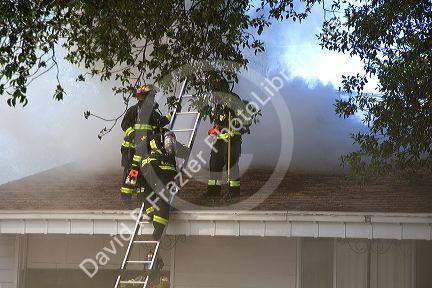 Firefighters fight a house fire on the roof in Boise, Idaho.