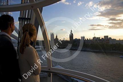 Tourists look at the Houses of Parliament from the London Eye in the city of London, England.