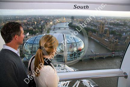 Tourists view the city of London from the London Eye, England.