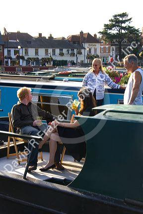 People socialize on boats in the River Avon at Stratford-upon-Avon, Warwickshire, England. MR