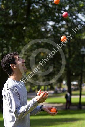 A man toss juggling balls in Boston Common public park in Boston, Massachusetts, USA. MR