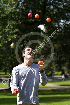 A man toss juggling balls in Boston Common public park in Boston, Massachusetts, USA. MR