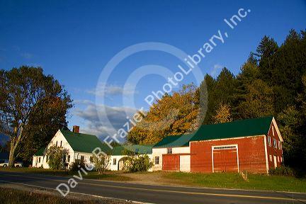 Red barn and residential home in the town of Wentworth, New Hampshire, USA.