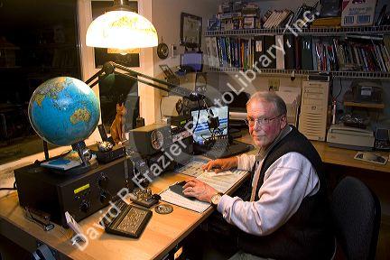 Ham radio operator in his radio shack located in Shelton, Washington, USA. MR