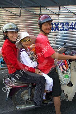 Vietnamese family ride a motorbike in Ho Chi Minh City, Vietnam.