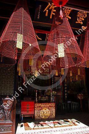 Large incense coils hang from the Phuoc Kien Assembly Hall in Hoi An, Vietnam.
