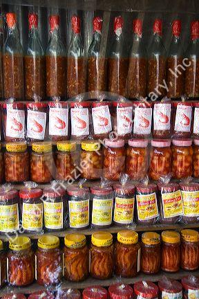 Vendor selling bottles of fish and shrimp sauces in the coastal town of Lang Co in Vietnam.