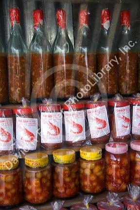 Vendor selling bottles of fish and shrimp sauces in the coastal town of Lang Co in Vietnam.
