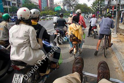Vietnamese people ride motorbikes in Ho Chi Minh City, Vietnam.