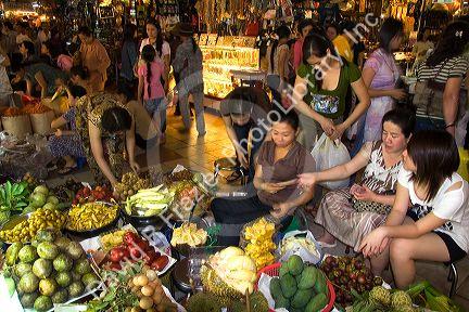 Vendors selling produce in the Ben Thanh Market located in Ho Chi Minh City, Vietnam.