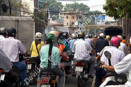 Vietnamese people ride motorbikes in Ho Chi Minh City, Vietnam.