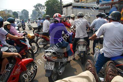 Vietnamese people ride motorbikes in Ho Chi Minh City, Vietnam.