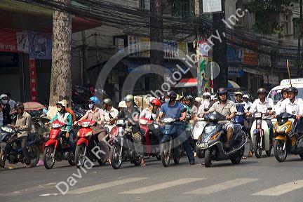 Vietnamese people ride motorbikes in Ho Chi Minh City, Vietnam.