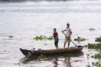 Sampan flat bottom wooden boat on the Saigon River in Ho Chi Minh City, Vietnam.