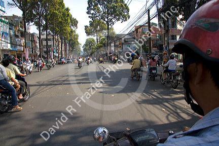 Vietnamese people ride motorbikes in Ho Chi Minh City, Vietnam.