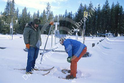Men dressed in warm clothing working in extreme conditions on a snow survey to determine water content.