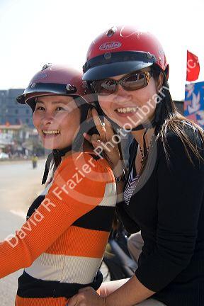 Modern Vietnamese women ride a motorbike in Dong Ha, Vietnam.