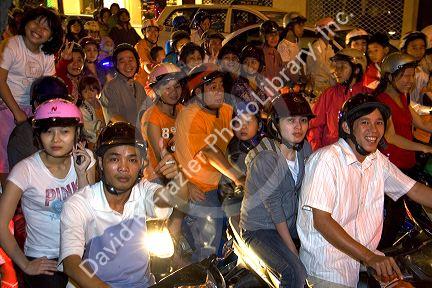 Vietnamese people ride motorbikes on Dong Khoi street during the last night of Tet Lunar New Year celebrations in Ho Chi Minh City, Vietnam.