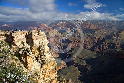 Tourists view the South Rim of the Grand Canyon, Arizona, USA.