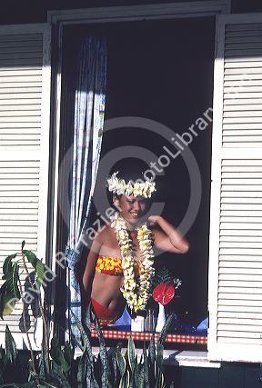 Young hawaiian girl in the window of the Pioneer Inn, Lahaina, Maui, Hawaii.