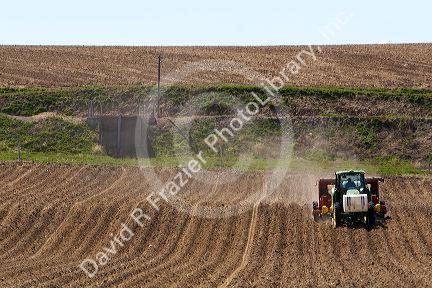 Farmer planting potato crop in Canyon County, Idaho, USA.