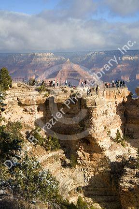 Tourists view the South Rim of the Grand Canyon, Arizona, USA.