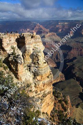 Tourists view the South Rim of the Grand Canyon, Arizona, USA.